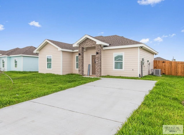 ranch-style home featuring central AC and a front lawn