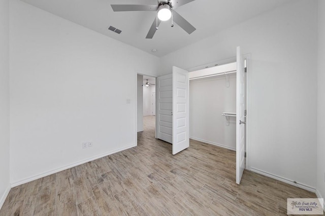 unfurnished bedroom featuring ceiling fan, light hardwood / wood-style flooring, and a closet