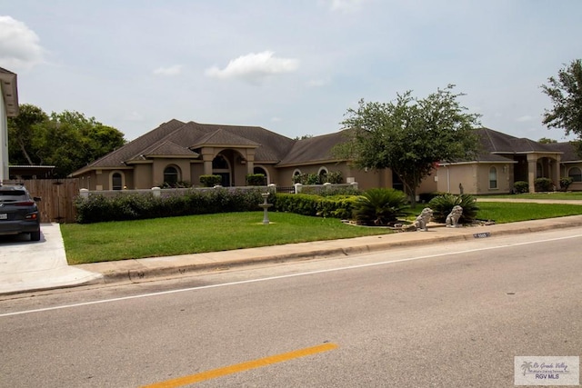 5303 Rustic Manor Dr, Brownsville, TX 78526 - french provincial home featuring fence and a front yard