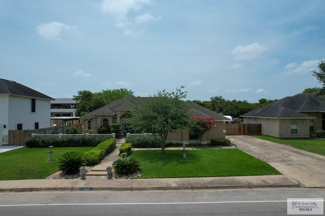 5303 Rustic Manor Dr, Brownsville, TX 78526 - view of front facade featuring a front lawn, fence, and concrete driveway