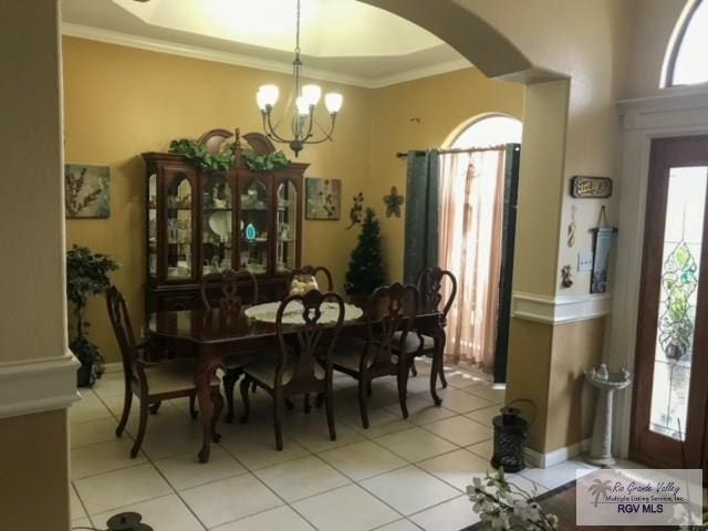 5303 Rustic Manor Dr, Brownsville, TX 78526 - dining space with crown molding, arched walkways, a chandelier, and light tile patterned flooring