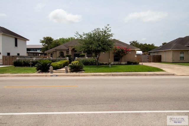 5303 Rustic Manor Dr, Brownsville, TX 78526 - view of front of house featuring fence and a front yard