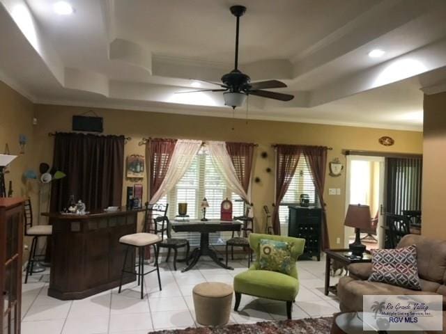 5303 Rustic Manor Dr, Brownsville, TX 78526 - living room with light tile patterned floors, a ceiling fan, and a tray ceiling