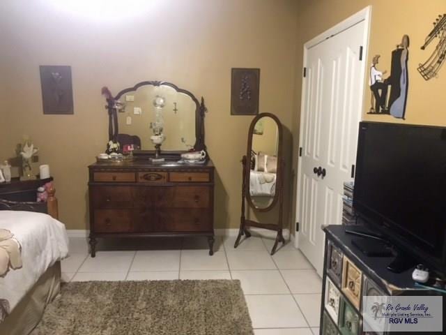 5303 Rustic Manor Dr, Brownsville, TX 78526 - bedroom with light tile patterned flooring and baseboards