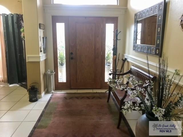 5303 Rustic Manor Dr, Brownsville, TX 78526 - entrance foyer with baseboards, tile patterned floors, and a wealth of natural light