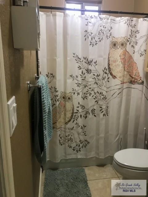 5303 Rustic Manor Dr, Brownsville, TX 78526 - full bathroom with tile patterned flooring, toilet, and shower / bathtub combination with curtain