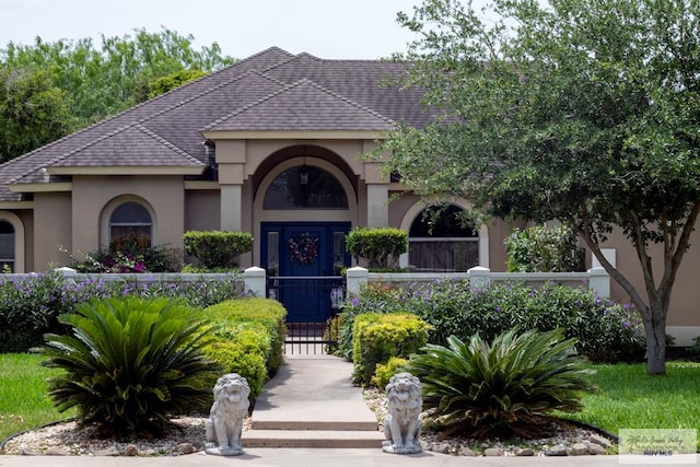 5303 Rustic Manor Dr, Brownsville, TX 78526 - view of front of property with a gate, stucco siding, and a fenced front yard