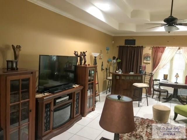 5303 Rustic Manor Dr, Brownsville, TX 78526 - living room featuring ornamental molding, ceiling fan, light tile patterned flooring, and a tray ceiling