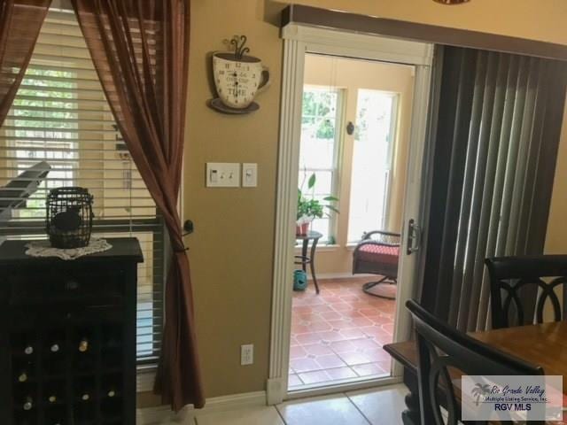 5303 Rustic Manor Dr, Brownsville, TX 78526 - doorway to outside featuring plenty of natural light, baseboards, and tile patterned floors