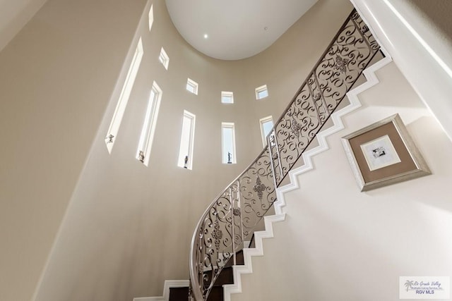 staircase with a towering ceiling