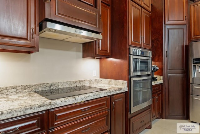 kitchen featuring under cabinet range hood, stainless steel appliances, light tile patterned floors, and light stone counters