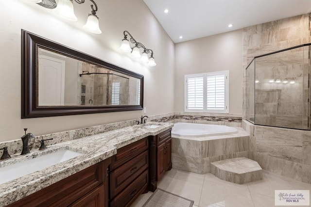full bath with tile patterned floors, a tile shower, a sink, and a bath