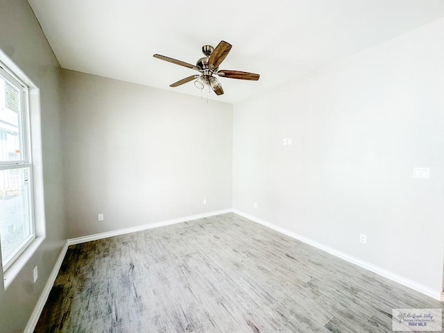 empty room with hardwood / wood-style floors and ceiling fan