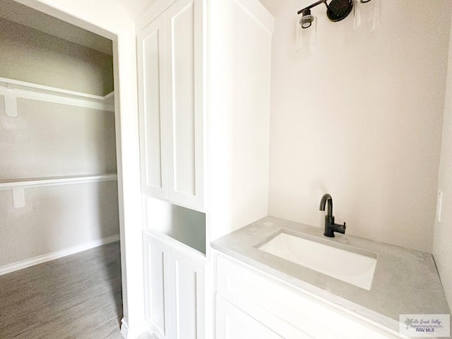 bathroom with hardwood / wood-style floors and vanity