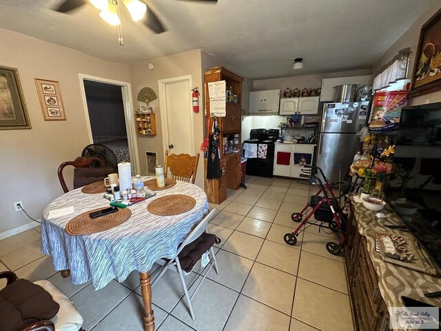 tiled dining area with ceiling fan