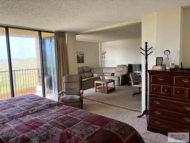 bedroom featuring access to exterior, floor to ceiling windows, light colored carpet, and a textured ceiling