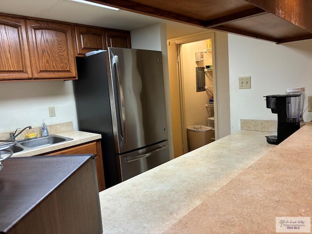 kitchen featuring stainless steel fridge and sink