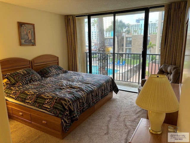 bedroom featuring floor to ceiling windows, light carpet, access to outside, and multiple windows