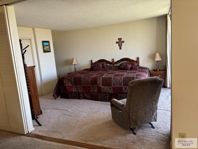 carpeted bedroom with a textured ceiling and a closet