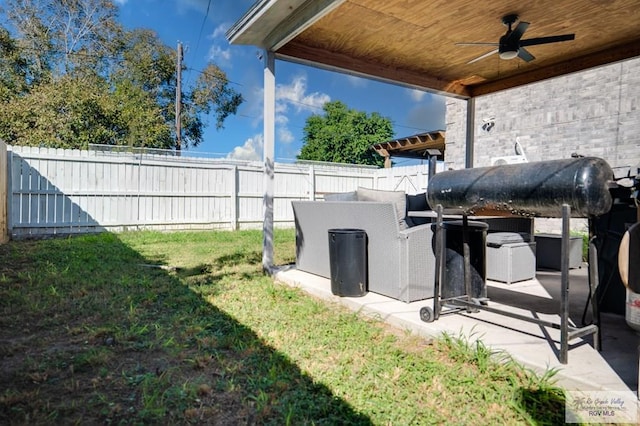 view of yard with ceiling fan and a patio