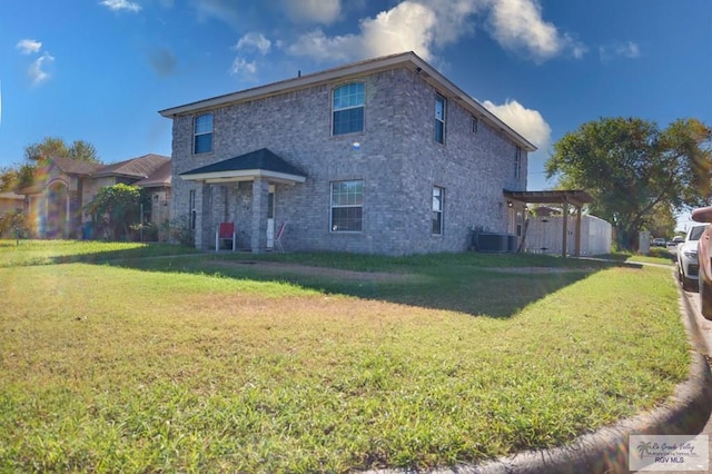 back of property with a yard and central AC