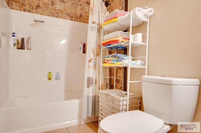 bathroom with tile patterned floors, shower / tub combo with curtain, and toilet