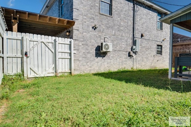 view of side of home featuring ac unit and a yard