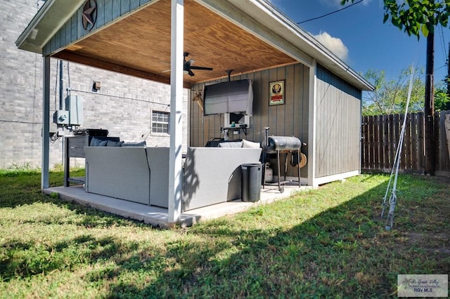 exterior space with ceiling fan and a lawn