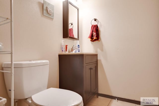 bathroom featuring tile patterned floors, vanity, and toilet