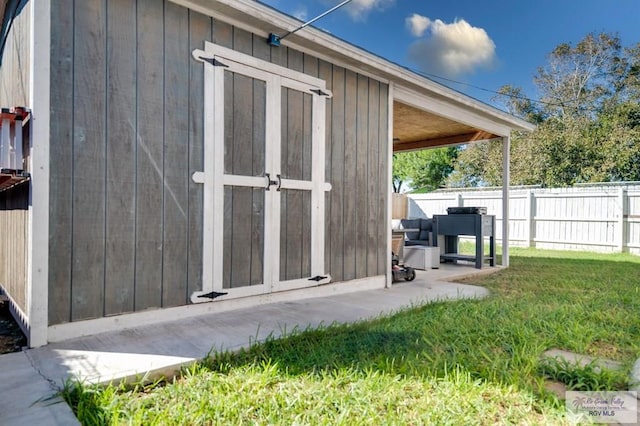 view of outbuilding with a lawn