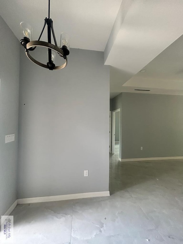 9910 Hawk Dr, Harlingen, TX 78550 - spare room featuring a chandelier and unfinished concrete flooring