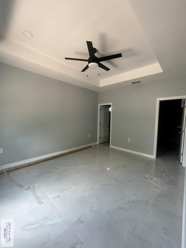 9910 Hawk Dr, Harlingen, TX 78550 - empty room with a tray ceiling and ceiling fan