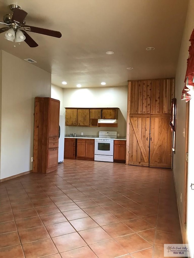 36282 Fm 2480, Los Fresnos, TX 78566 - kitchen featuring white electric range, recessed lighting, brown cabinets, ceiling fan, and under cabinet range hood