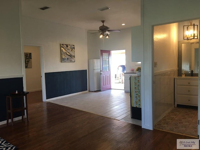 interior space with dark wood-type flooring and ceiling fan