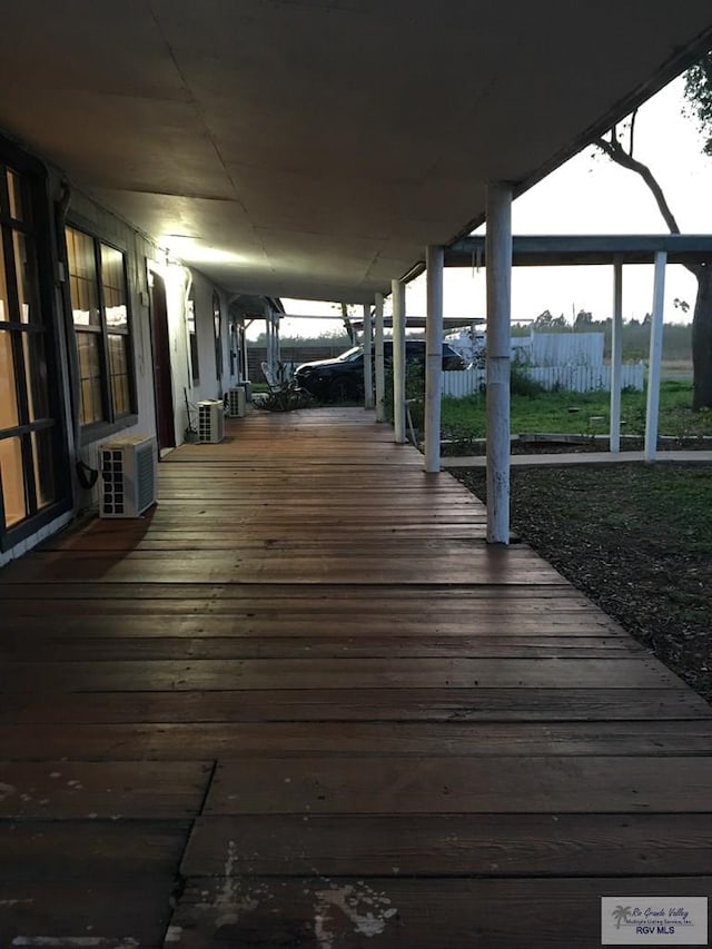 deck featuring an AC wall unit and central AC