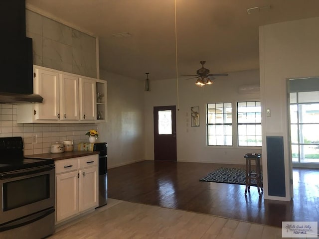 36282 Fm 2480, Los Fresnos, TX 78566 - kitchen featuring white cabinetry, wood finished floors, exhaust hood, ceiling fan, and stainless steel range with electric stovetop