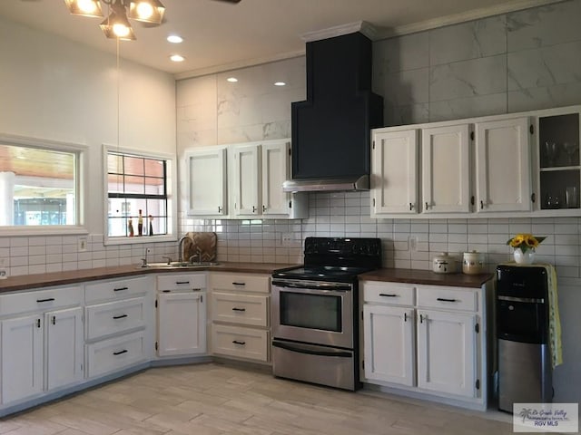 kitchen featuring stainless steel electric stove, white cabinetry, sink, decorative backsplash, and light hardwood / wood-style flooring