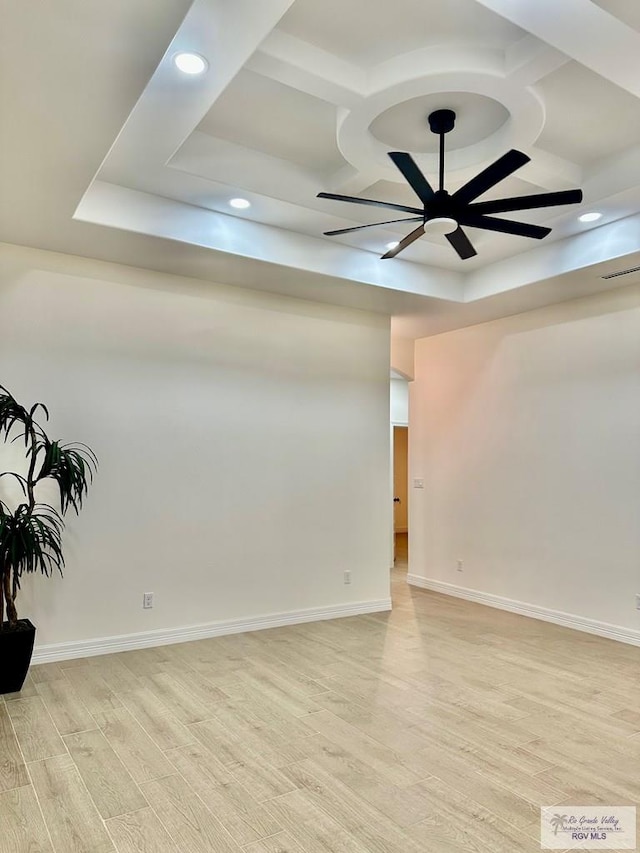 1521 Stirrup Cir, San Benito, TX 78586 - empty room featuring light wood-style floors, a raised ceiling, recessed lighting, a ceiling fan, and baseboards