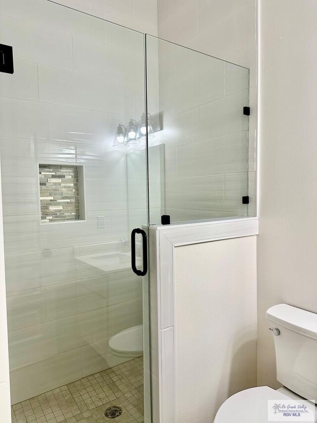 1521 Stirrup Cir, San Benito, TX 78586 - full bath featuring toilet, a stall shower, and tile patterned flooring