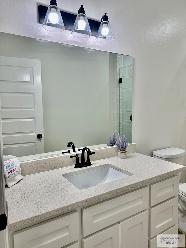 1521 Stirrup Cir, San Benito, TX 78586 - full bathroom featuring toilet and vanity