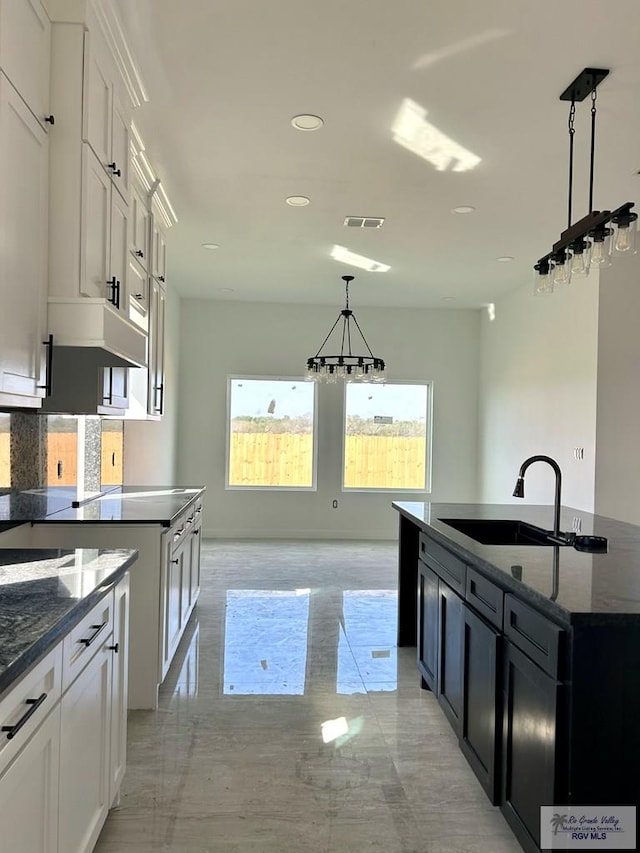 unfurnished room featuring a tray ceiling and a wealth of natural light