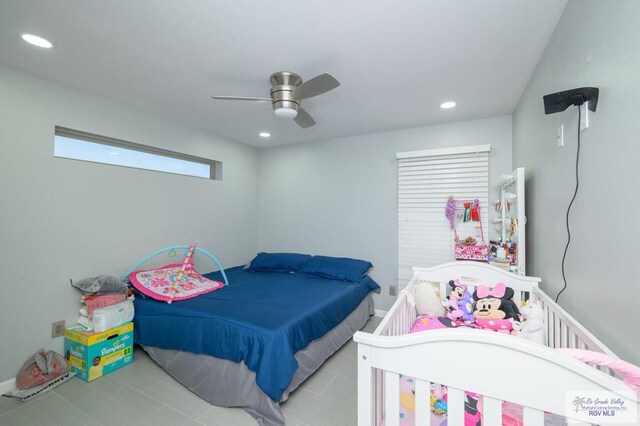 tiled bedroom featuring ceiling fan