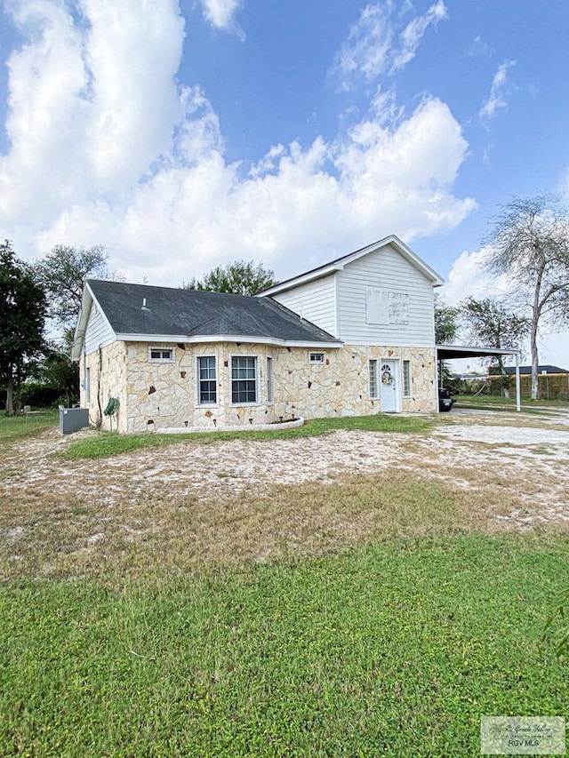 exterior space with a yard and a carport