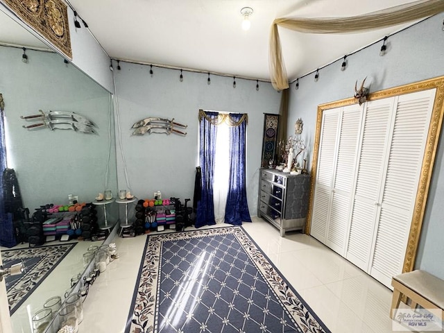 bedroom with a closet and tile patterned flooring