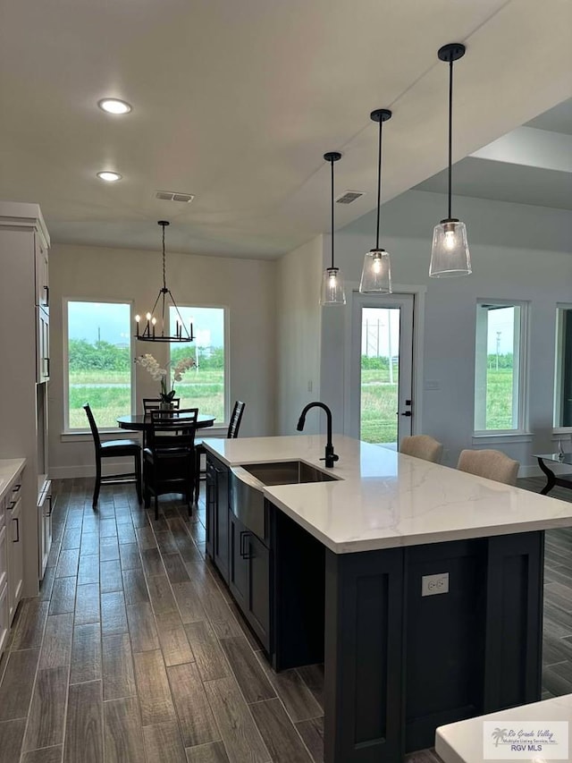 3518 Treasure Hills Blvd, Harlingen, TX 78550 - kitchen featuring dark wood-style flooring, healthy amount of natural light, an island with sink, recessed lighting, and decorative light fixtures