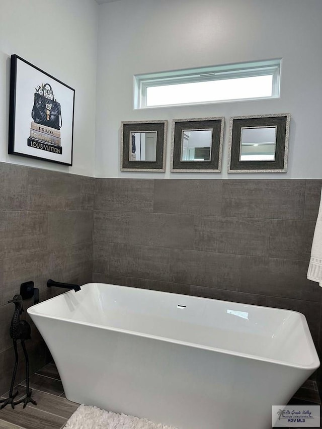 3518 Treasure Hills Blvd, Harlingen, TX 78550 - full bathroom with tile walls, plenty of natural light, and a freestanding bath