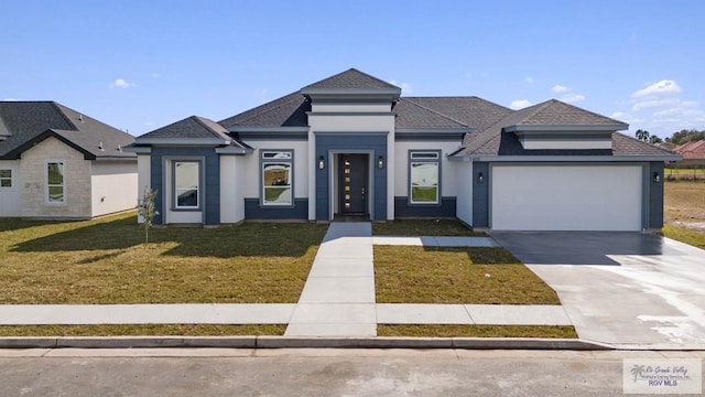 view of front of house with a front lawn and a garage