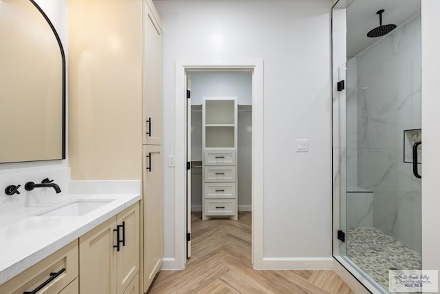 bathroom with vanity, an enclosed shower, and parquet floors