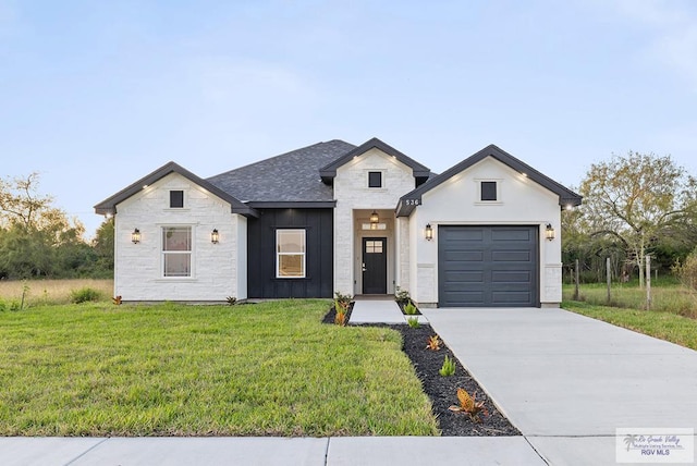 modern inspired farmhouse with a garage and a front lawn