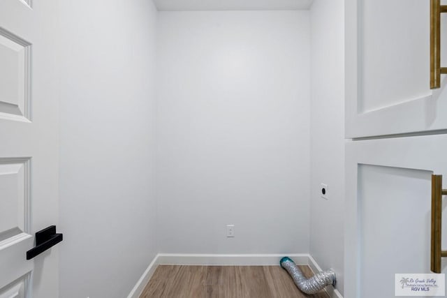 laundry area with wood-type flooring and hookup for an electric dryer